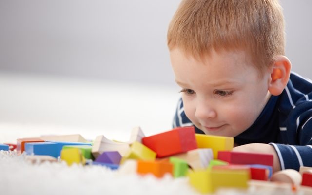 Child looking at blocks - Enunciate Child looking at blocks